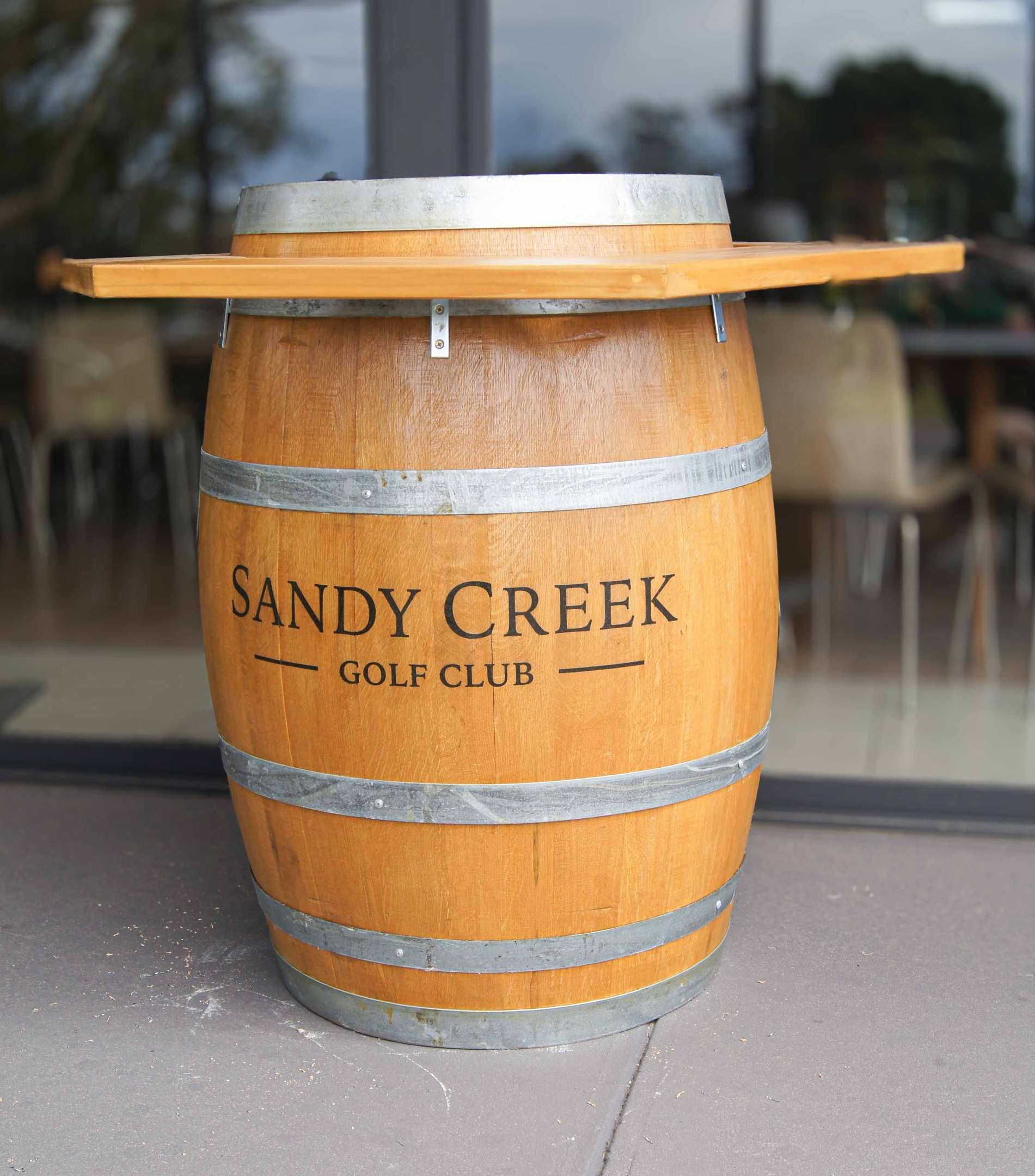 White wine barrel sitting on deck infront of white house